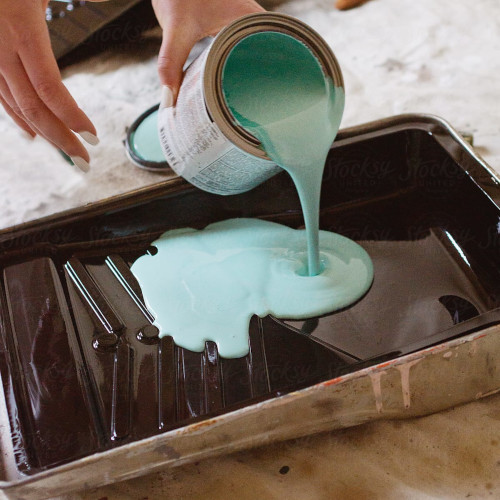 Paint being poured into a tray